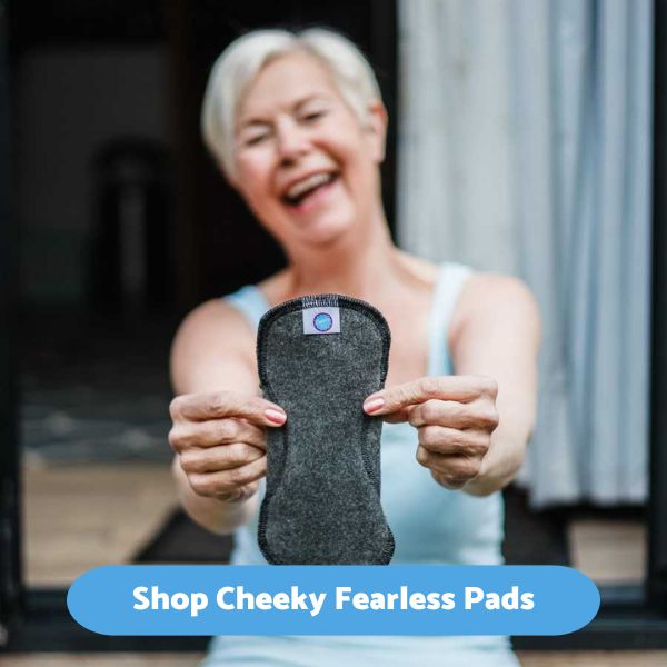 Lady holding a cotton incontinence pad in front of her and smiling