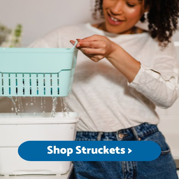 Lady lifting the strainer elements from our combined strainer & bucket (the strucket)